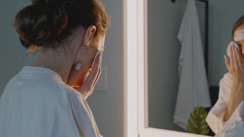 A woman applying Korean skincare cream for a glowing, hydrated complexion with Ferozia's premium K-beauty products.