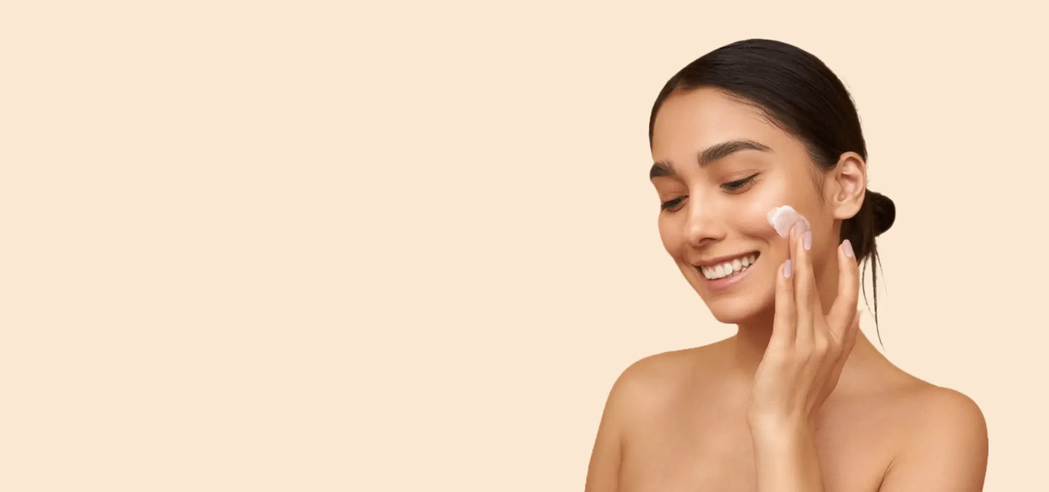 A model applying a hydrating skincare cream to her face, showcasing a smooth and radiant complexion. Perfect for promoting skincare routines and K-beauty products.